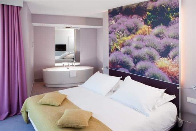 Discover a stylish hotel room in Split adorned with exquisite purple curtains and an impressive wall painting. This is the perfect place to stay in Split, offering unparalleled comfort and visual appeal.